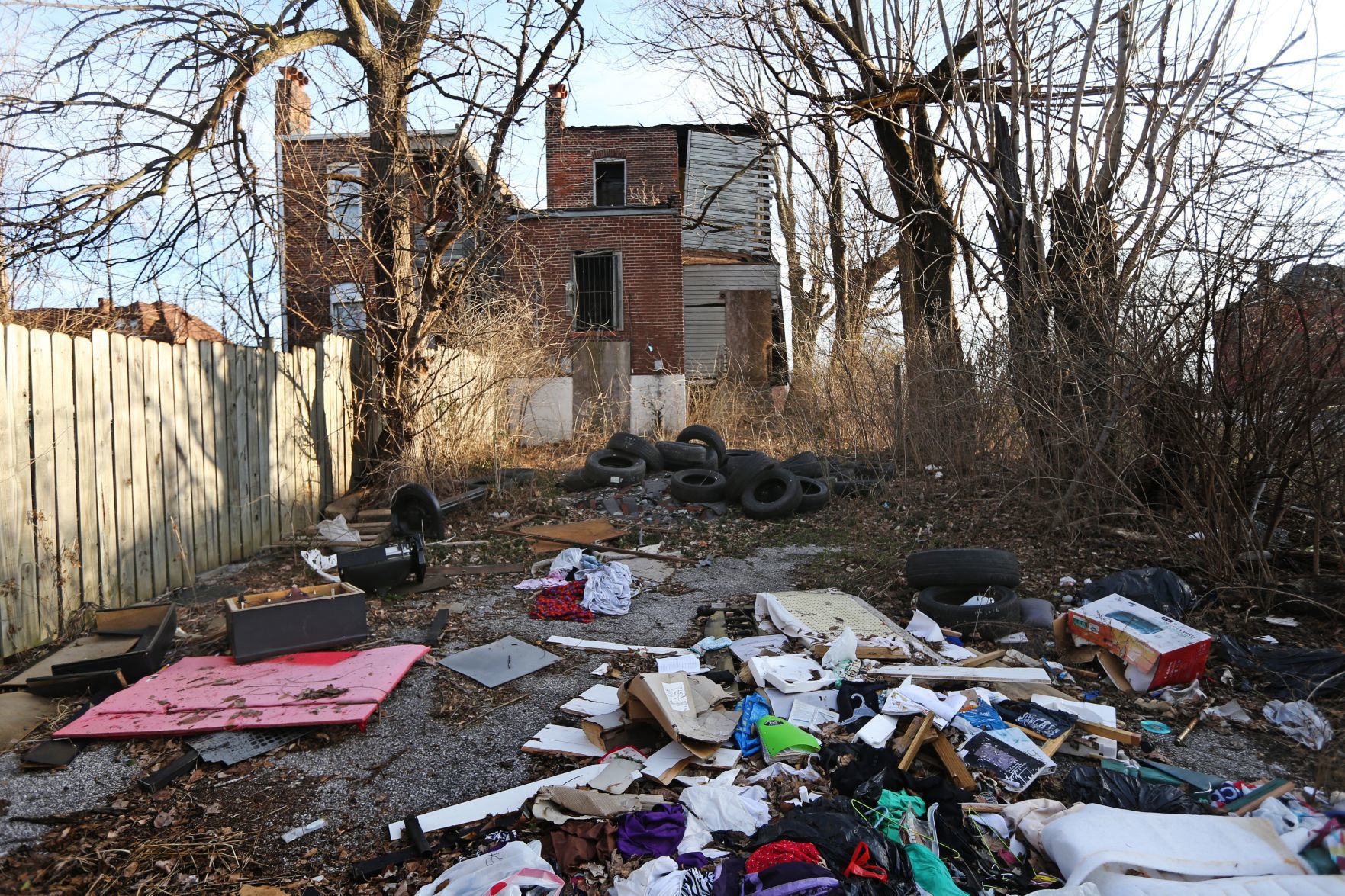 Tires and trash piled up behind a home in the 4300 block of 19th Street